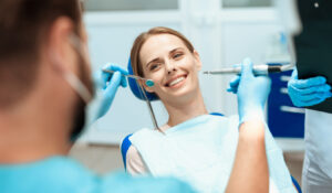 woman-sits-dental-chair-doctors-bowed-her Ainos Dental